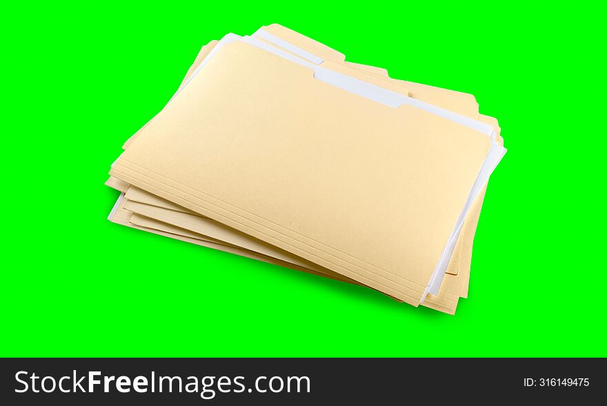 stack of yellow folders with blank labels on a green background. chroma key.