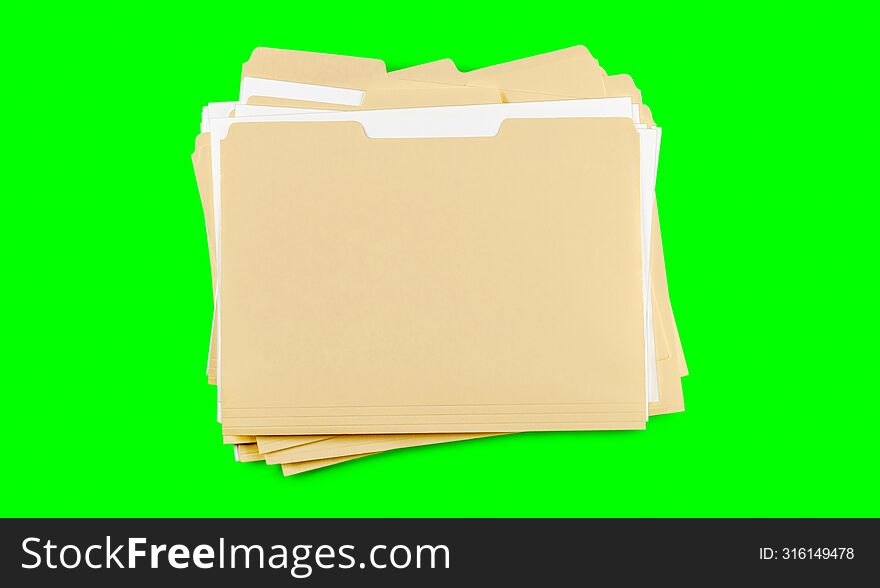 A stack of  folders with blank labels on a green background. chroma key.