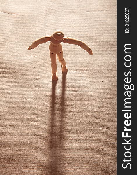 A wooden figure with its shadow.