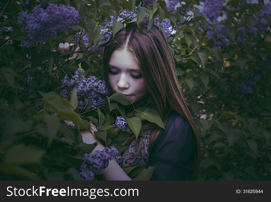 Beauty Young Girl In Fashion Style Smells Lilac Flowers Outdoors