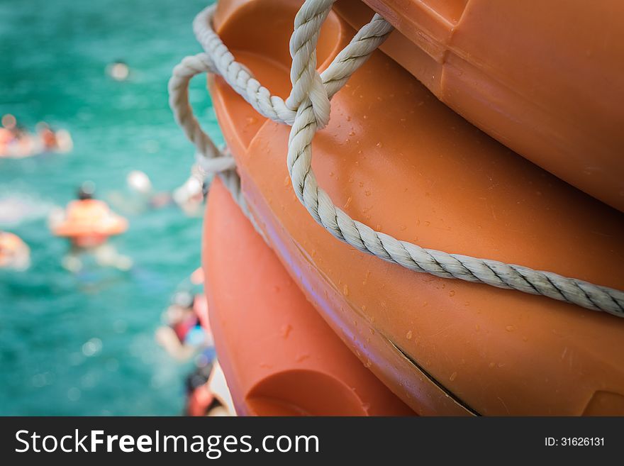 Life buoy with people swimming in the sea