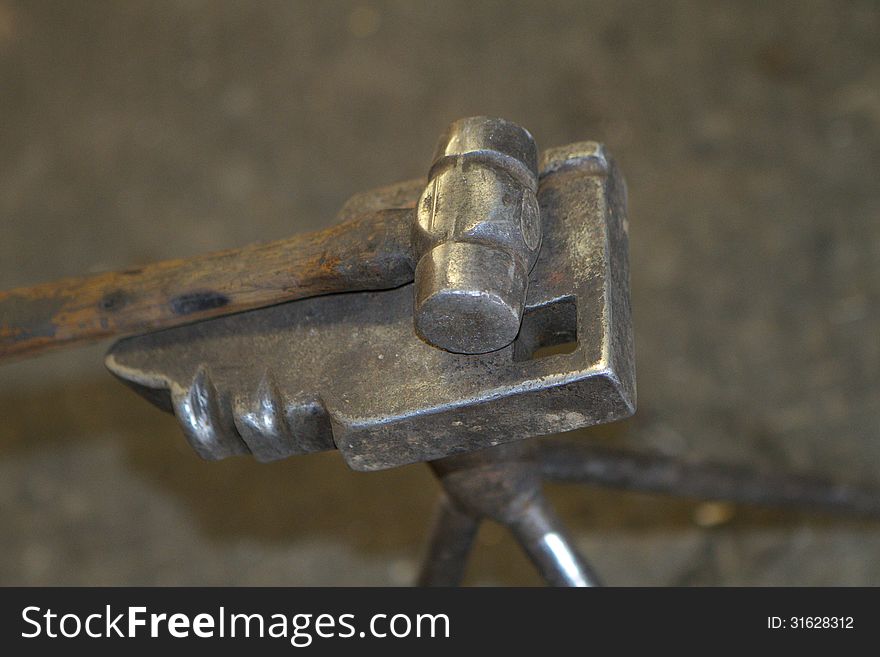 Close-up of a Blacksmith's hammer atop an anvil. Close-up of a Blacksmith's hammer atop an anvil.