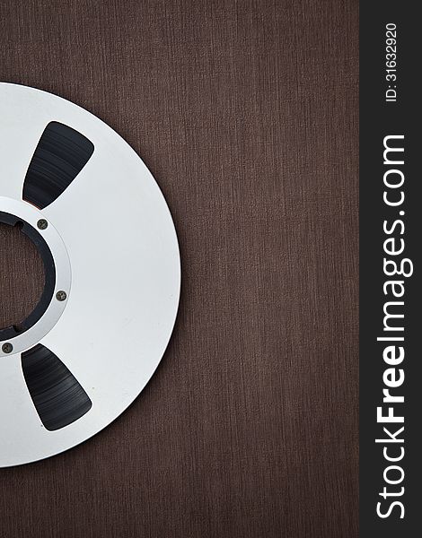 Professional audio metal reel on brown background