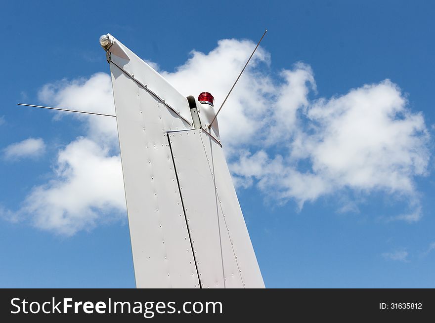 The tail empennage against the sky with clouds. The tail empennage against the sky with clouds