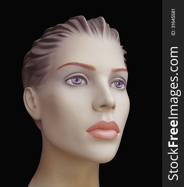 Close-up of the face of a female mannequin. Isolated on black. Close-up of the face of a female mannequin. Isolated on black.