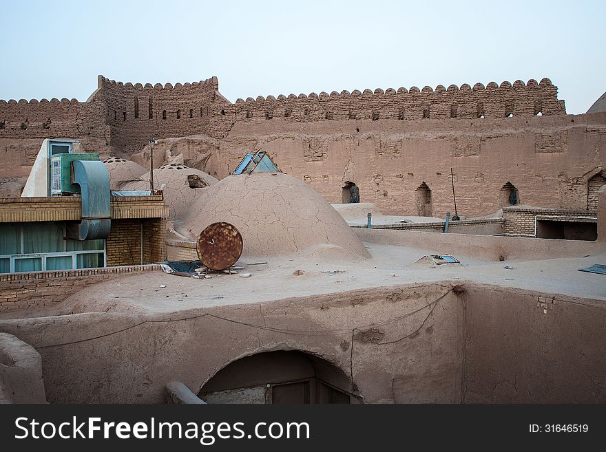 Traditional adobe houses and a fortification wall in Yazd, Iran