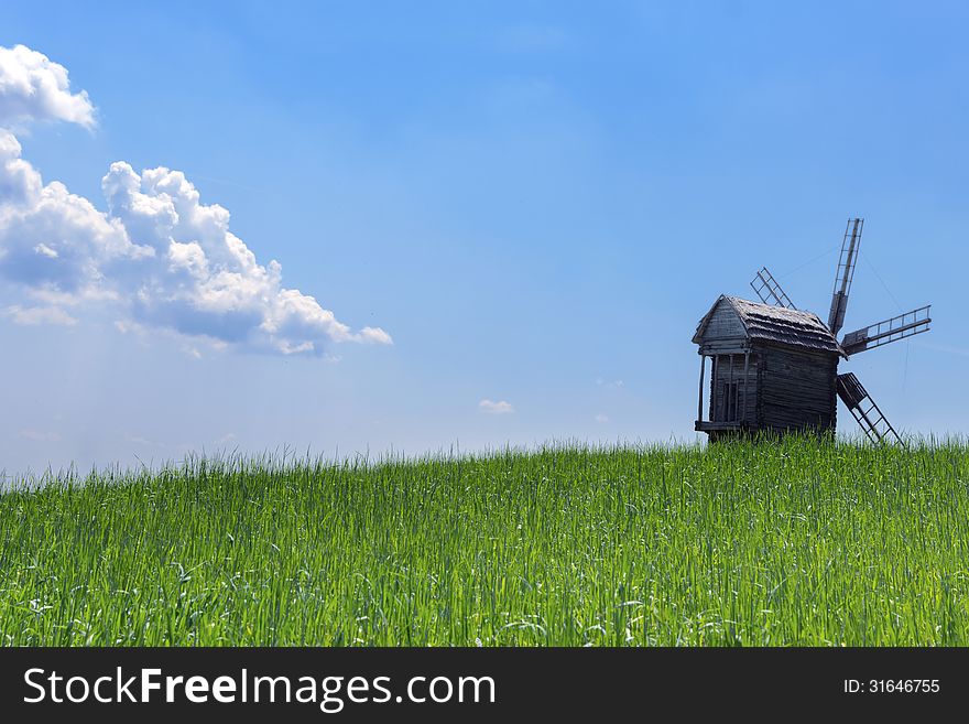 Scenic rural agriculture green field old windmills