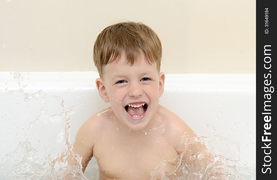 Cute three year old boy taking a bath with foam. Cute three year old boy taking a bath with foam