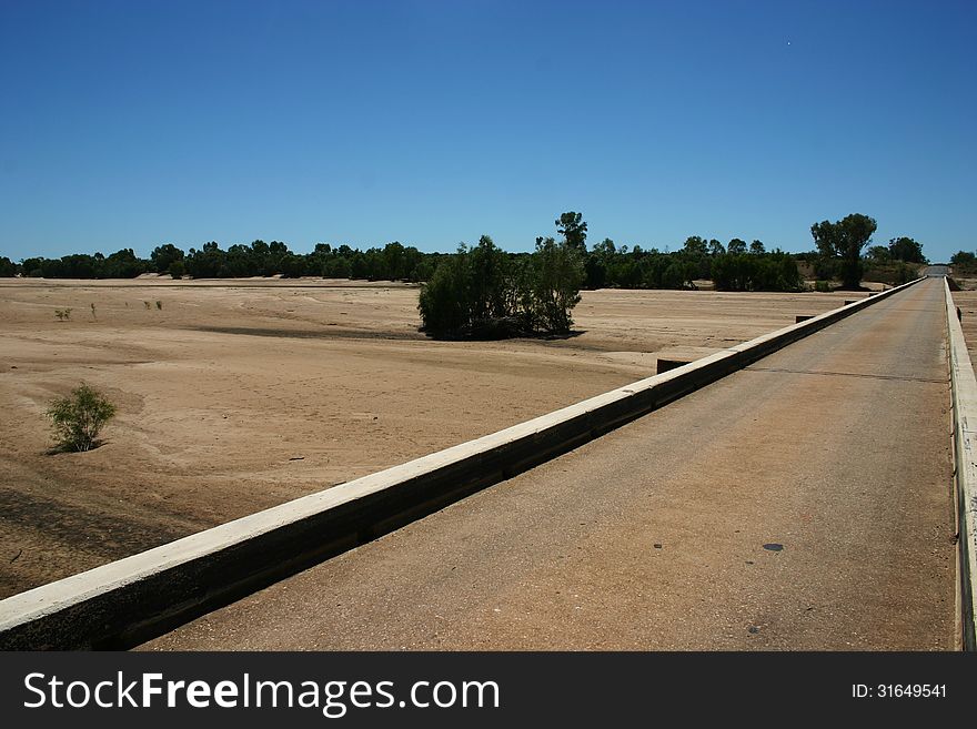 Dry river bed Australia with bridge transcending.