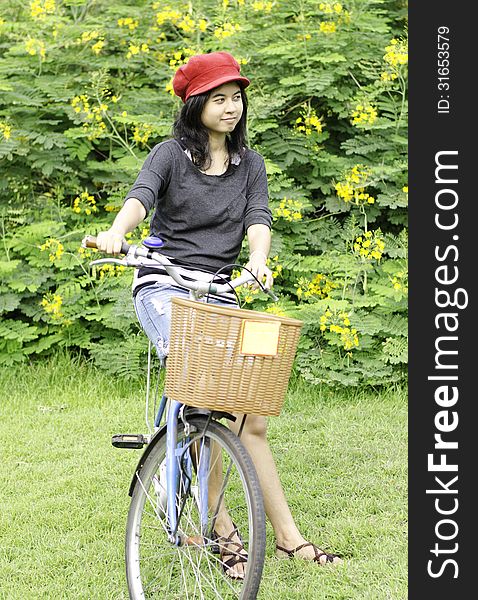 Young woman with retro bicycle in a park - outdoor portrait