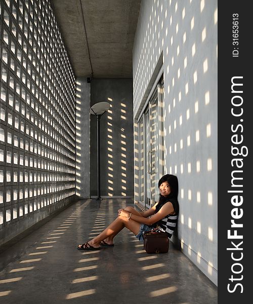 Asian Girl Sitting On Corridor Floor