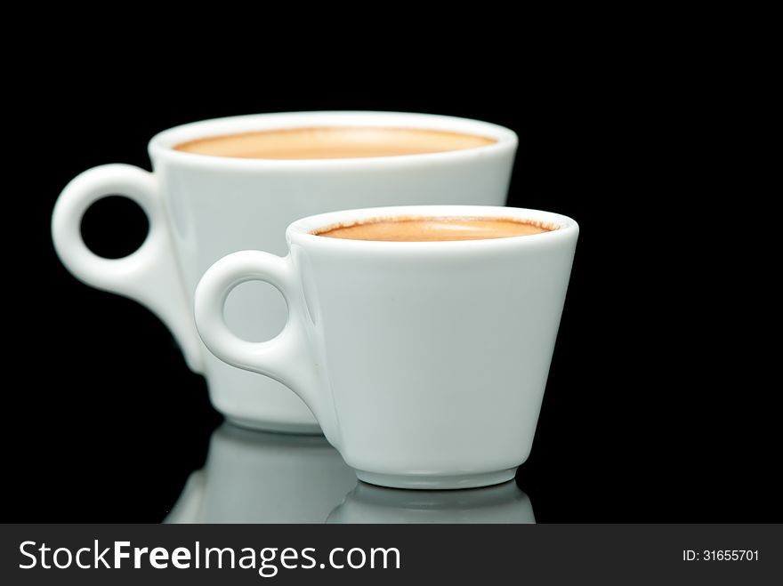 Two white coffe cups on the black background