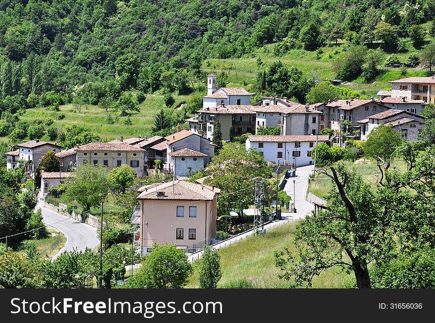 Image shows typical italian village Voltino within the national park of Tremosine, Italian. Village is surrounded by mountains, trees and meadows. Image shows typical italian village Voltino within the national park of Tremosine, Italian. Village is surrounded by mountains, trees and meadows.
