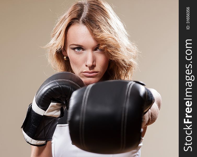 Portrait of blonde sportish woman in boxing gloves. Portrait of blonde sportish woman in boxing gloves