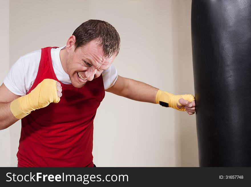 Man Makes Exercises With Punching Bag