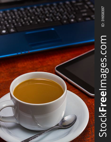 Coffee cup and Laptop on wooden table. Coffee cup and Laptop on wooden table