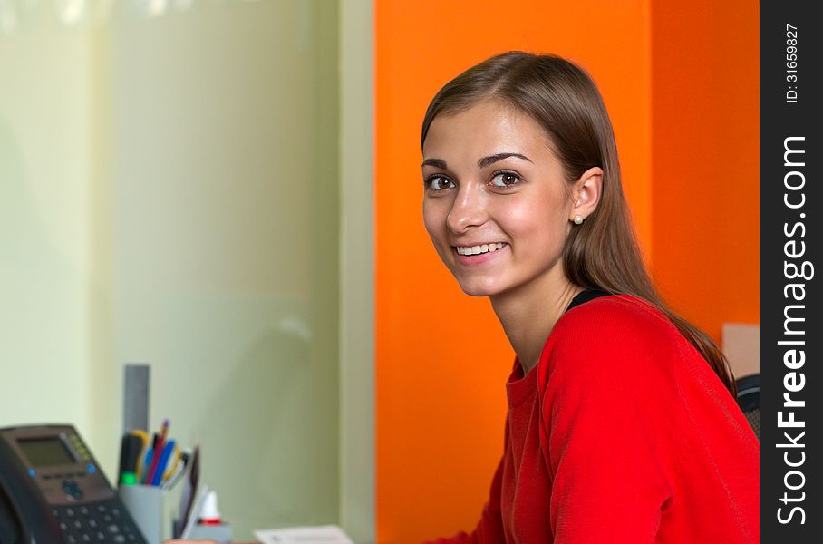 Beautiful girl in bright clothes at your desk. Beautiful girl in bright clothes at your desk