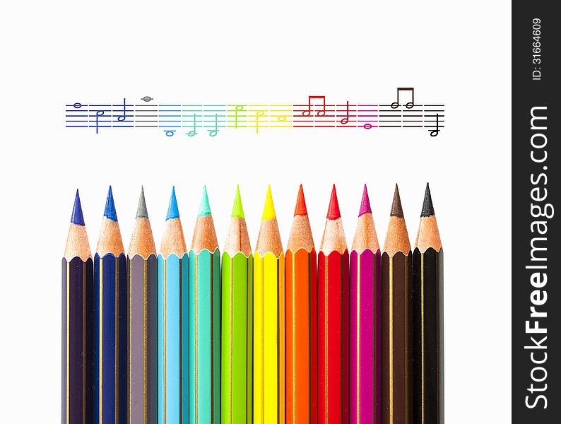 Colour pencils on an musical score. Colour pencils on an musical score