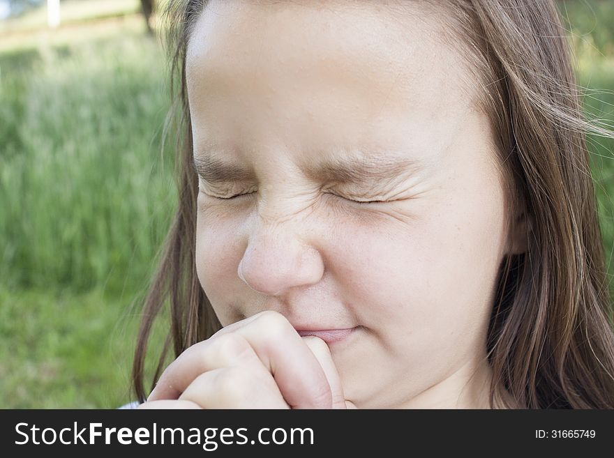 Young Girl squinting hard with hands squeezed tight. Young Girl squinting hard with hands squeezed tight.