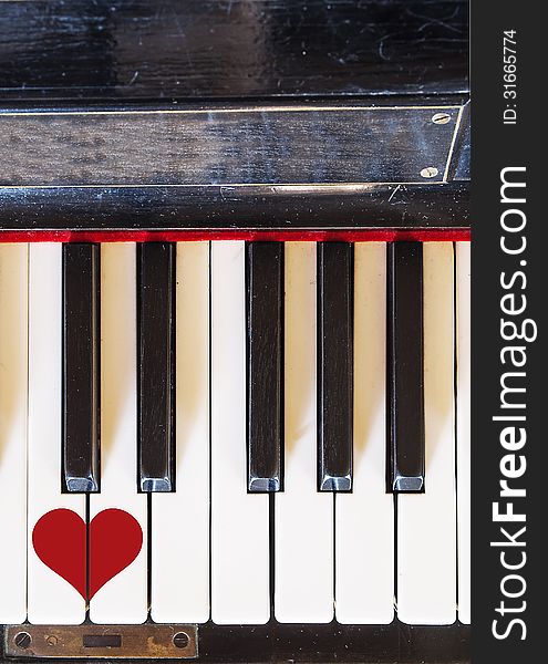 Piano keyboard top view with a painted heart. Piano keyboard top view with a painted heart