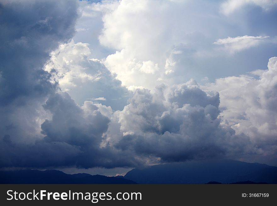 Cloudy sky background with white and black cloud