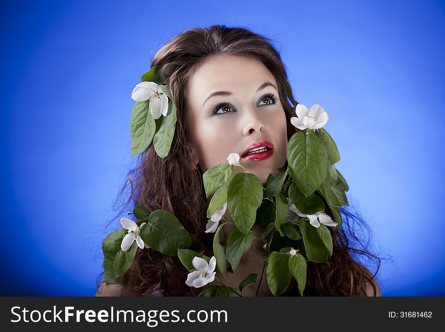 Beautiful girl with flowers. Professional make up, glamour skin