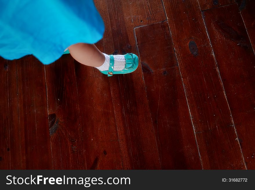On a brown background of children's feet in blue shoes. On a brown background of children's feet in blue shoes