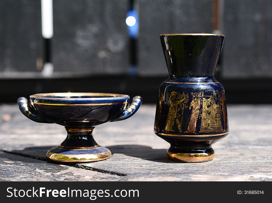 Cup and an urn with Greek motifs. Cup and an urn with Greek motifs