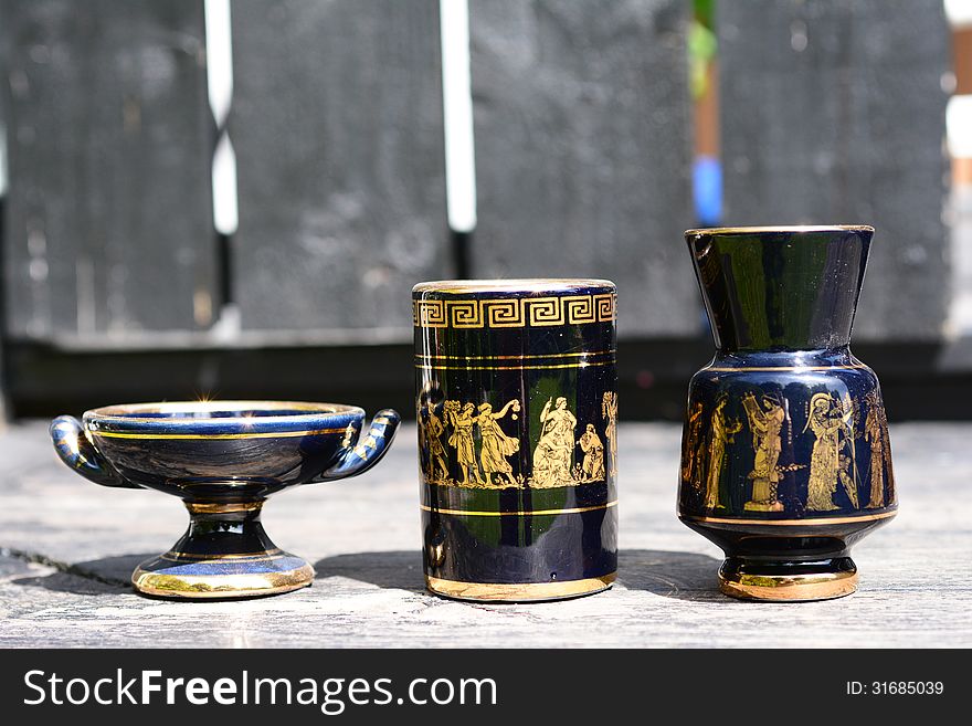Cup and an urn with Greek motifs. Cup and an urn with Greek motifs