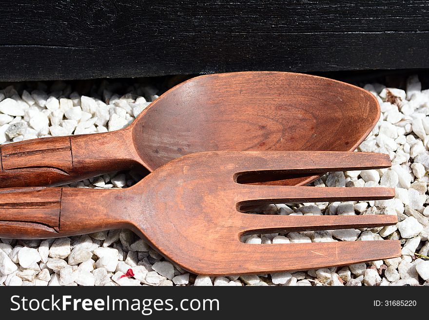 Wooden spoons on stones in the sun