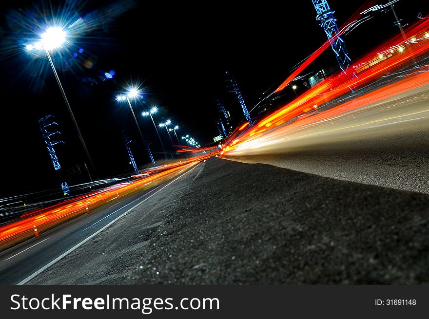 Red car light trails in highway. Red car light trails in highway.