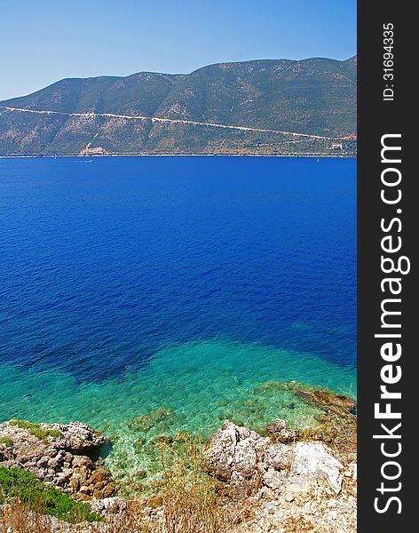 View of the blue sea, shore and horizon in the background. View of the blue sea, shore and horizon in the background