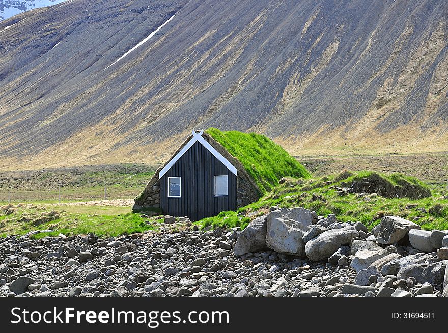 Icelandic turf house and mountains