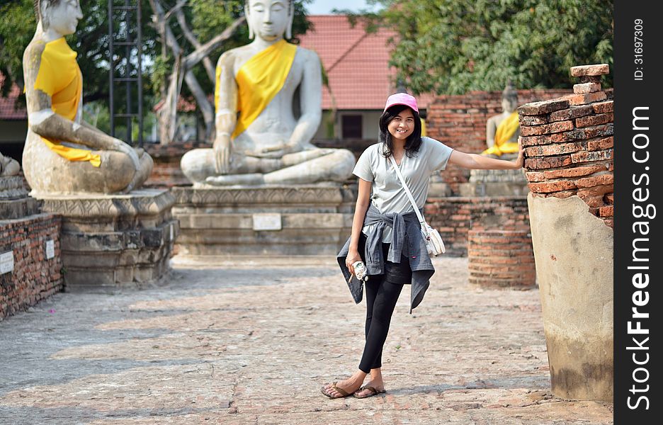 Asian Woman And Buddha At Wat Yai Chai Mongkol Temple. Ayutthaya