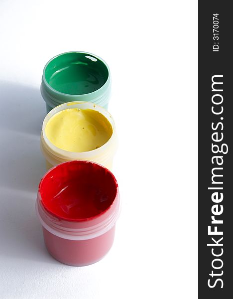Three jars with paints of different colours