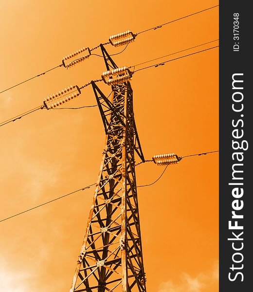 Electricity pylon on sky background, orange toning