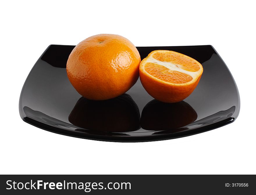 Photo of a tangerines on a black dish.  Isolated. Clipping path.