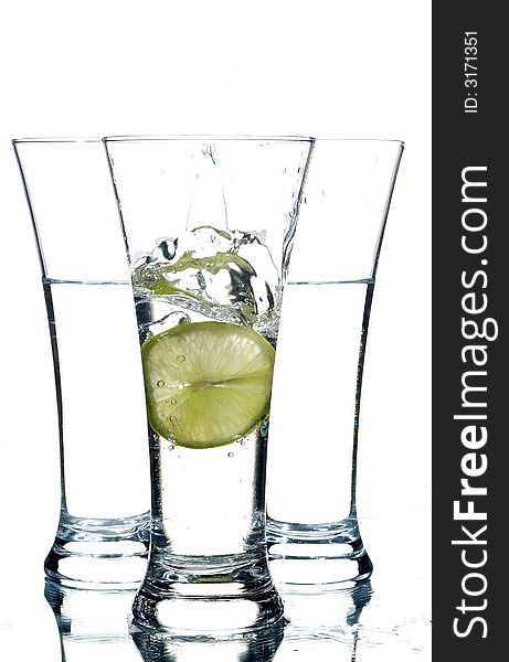 Glasses with water and lemon on the white background