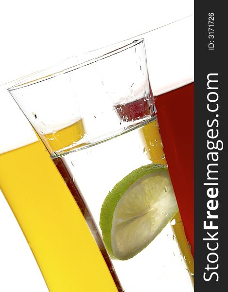 Glasses with juice and lime on the white background