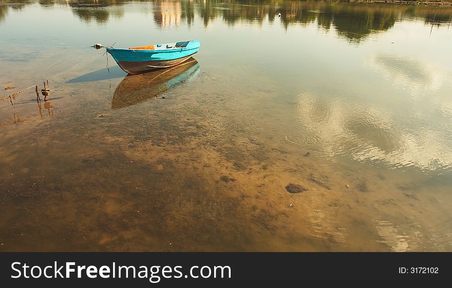 Sea landscape with reflection of clouds and a boat. Sea landscape with reflection of clouds and a boat
