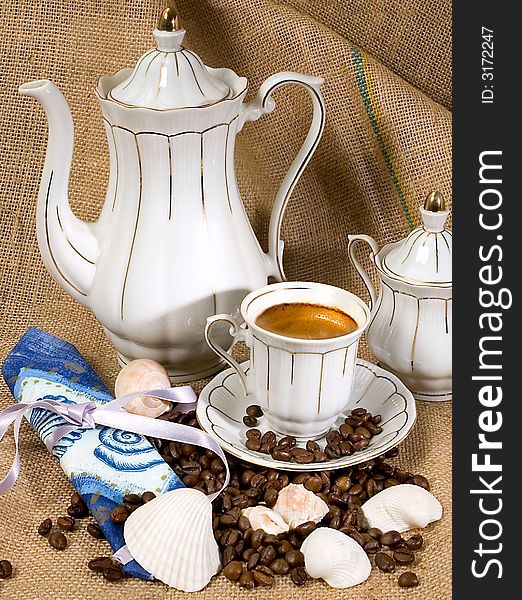 Retro style coffee cup and coffee beans with shells