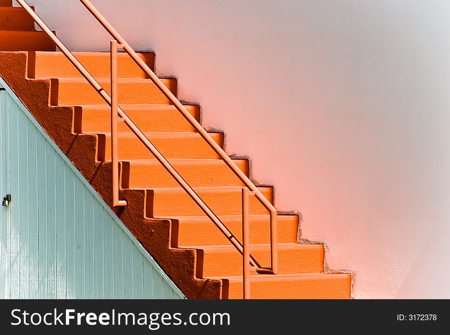 Pink staircase against a white wall