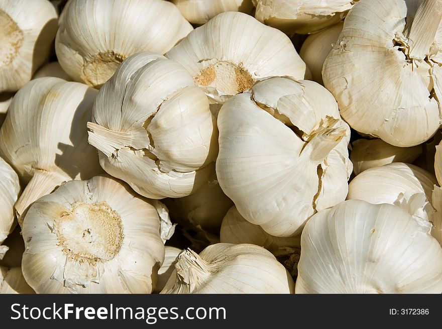 A market stall stacked with garlic cloves. A market stall stacked with garlic cloves