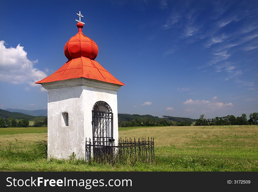 Rustic Christian chapel with red roof