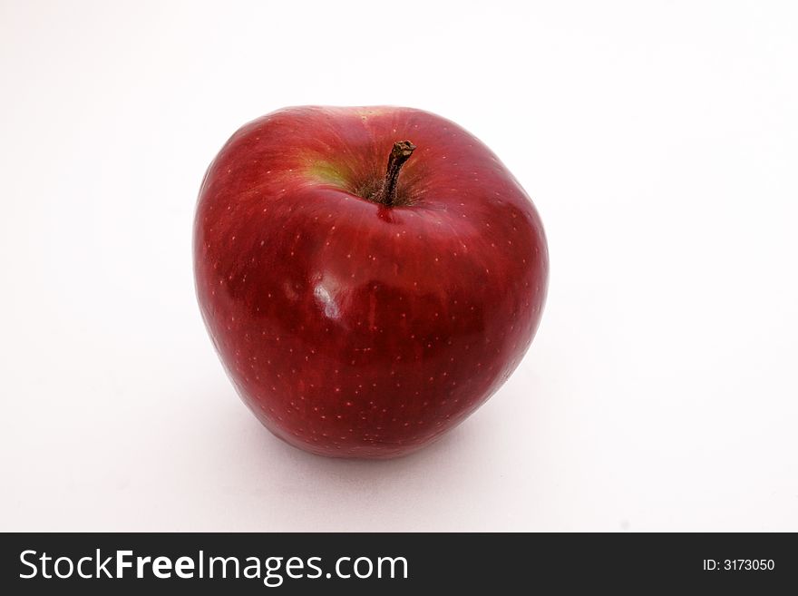 Juicy red apple on the white background