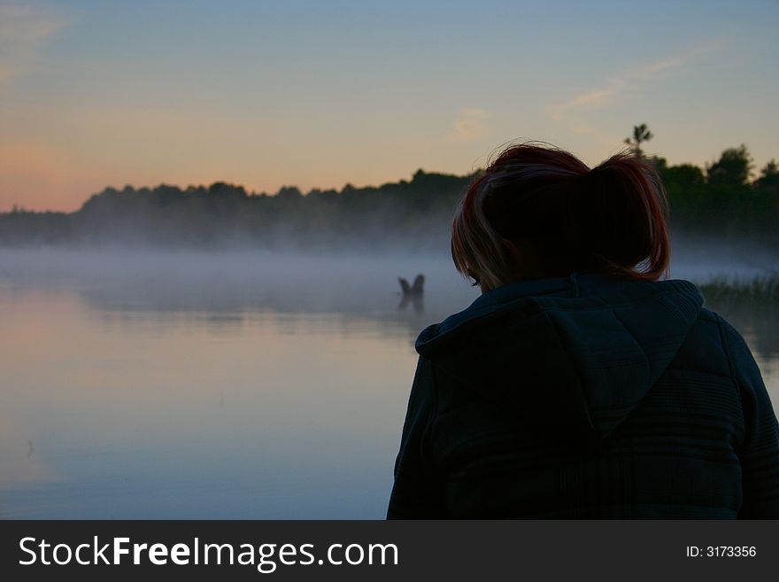 Pretty Girl On Lake At Sunrise