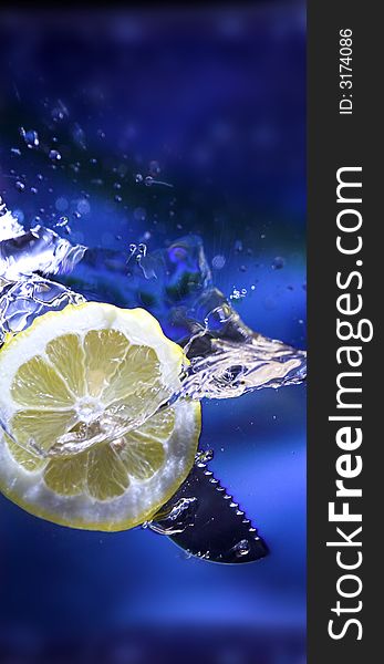 Lemon splash in transparent glass over blue background