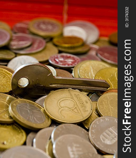 Euro coins in stack with a key, illustration
