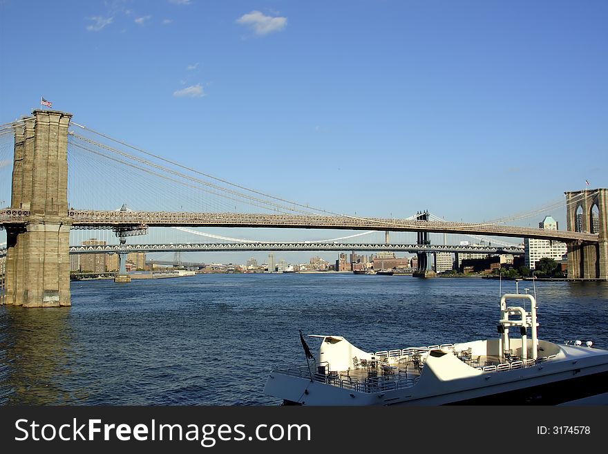 Brooklyn bridge Manhattan New York with boat in foreground