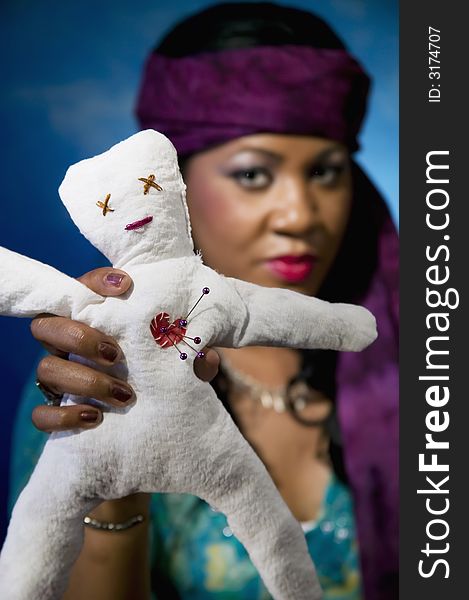 Gypsy fortune teller with an unfortunate voodoo doll.